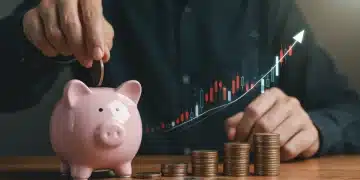 Hand putting coins in a piggy bank, representing savings growth from Federal Reserve rate decisions.